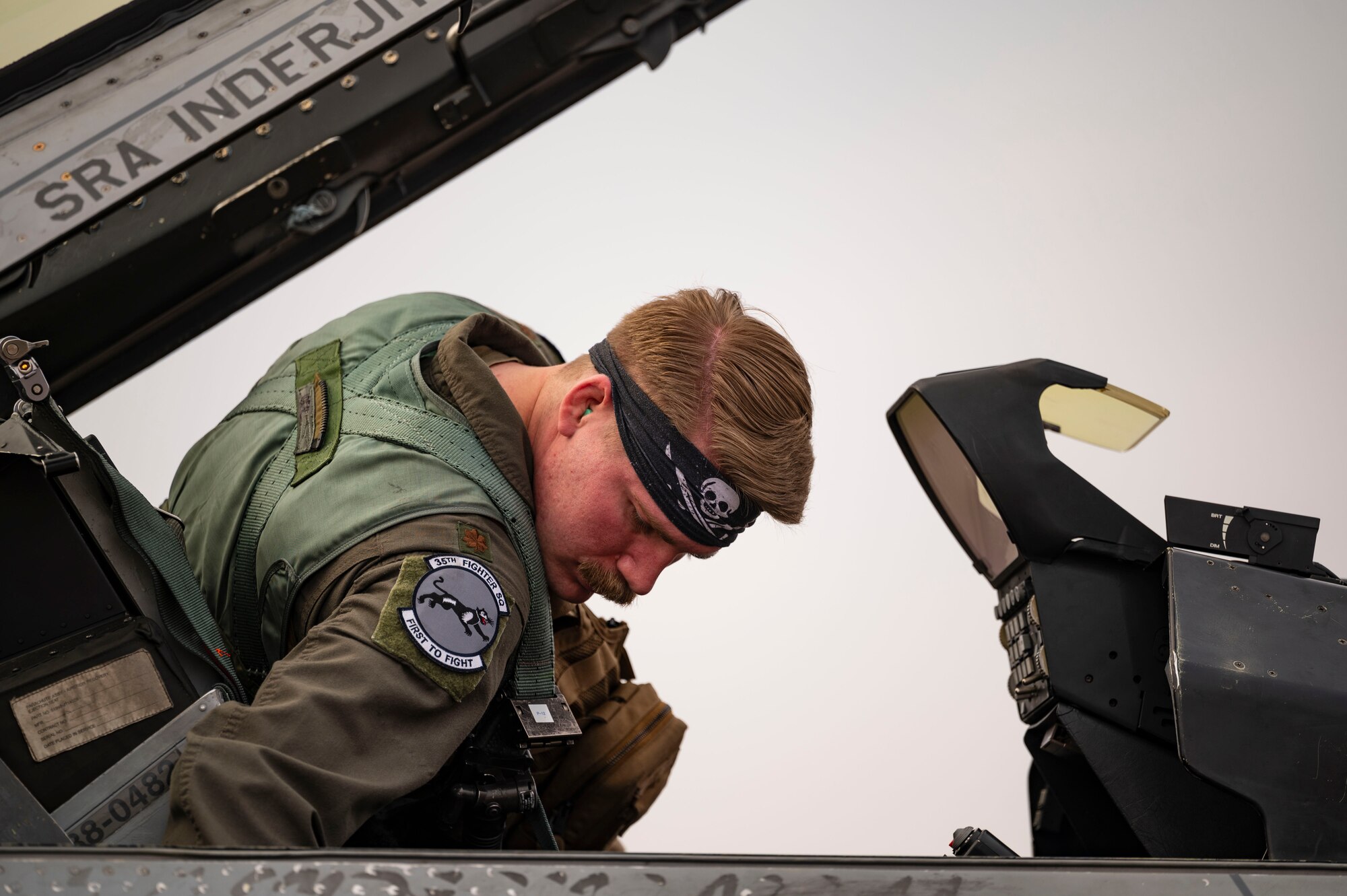 Maj. Gregory Rinker, 35th Fighter Squadron F-16 Fighting Falcon pilot, boards an F-16 for a routine training flight