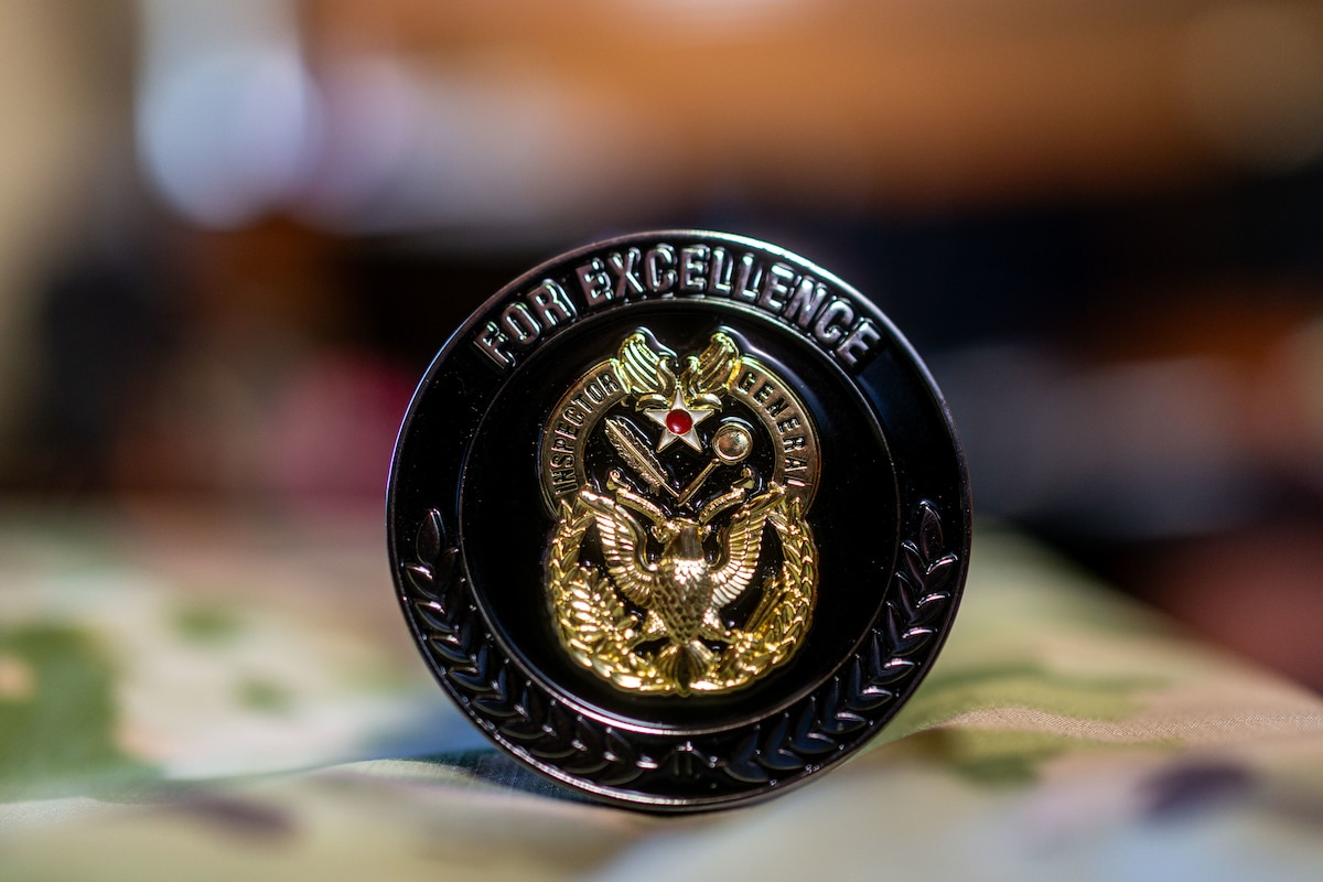 Photo of a coin on top of a camouflage surface.