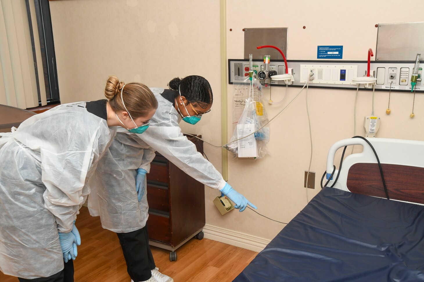 Lejeune High School students Katherine Scott (left) and McKenzie Pankey learn about medical equipment in the multi-service ward of Naval Medical Center Camp Lejeune on March 5, 2024. Scott and Pankey are enrolled in the high school’s Health Sciences/Nurse Aide I Program led by Dr. Angelia Washington, a nurse educator and founder of the program.