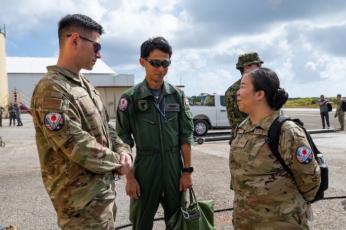 Senior Airman Yayoi Brown (right), a Cope North 24 Japanese interpreter and LEAP Scholar, speaks with multinational partners during a Cope North distinguished visitor tour at Northwest Field, Guam, Feb. 13, 2024. Cope North enhances U.S. relationships and interoperability with our regional Allies and partners in support of regional security. (U.S. Air Force photo by Senior Airman Tylir Meyer)