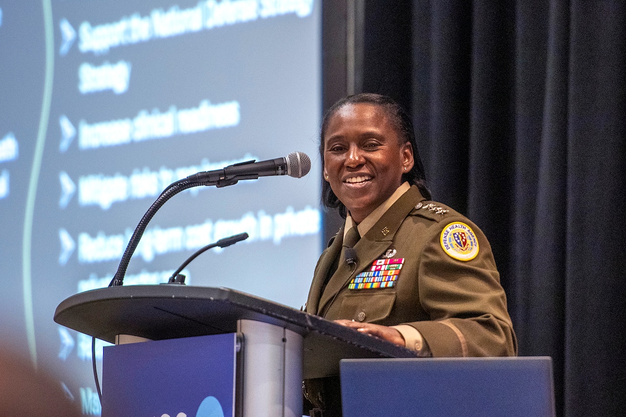 An Army officer speaks from behind a podium.