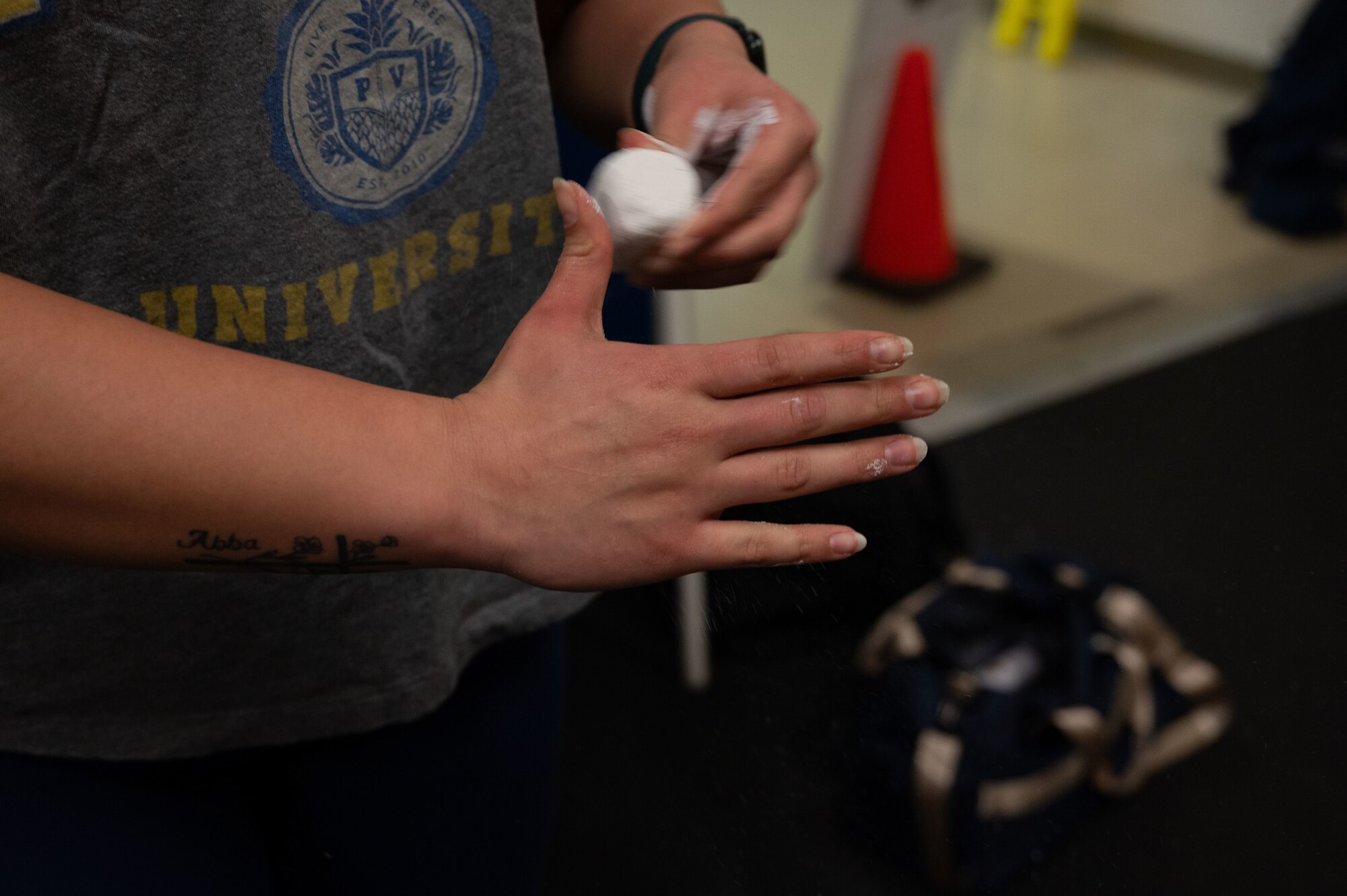 U.S. Air Force Airman Noelle Jennings, 436th Medical Group family health technician, uses chalk during a CrossFit class at Dover Air Force Base, Delaware, March 14, 2024. The Dover AFB Fitness Center CrossFit class is an ongoing program open to all active duty, reserve, spouses and Department of Defense card holders. (U.S. Air Force photo by Airman 1st Class Dieondiere Jefferies)