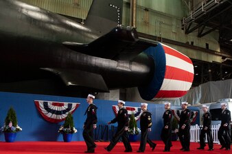 Sailors march in formation during the christening ceremony for PCU Idaho (SSN 799) at the General Dynamics Electric Boat shipyard facility in Groton, Conn.