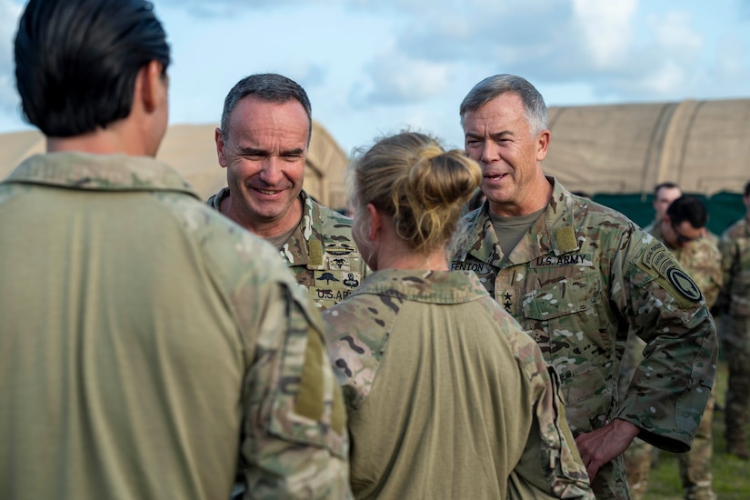 Army officers chat with enlisted soldiers.