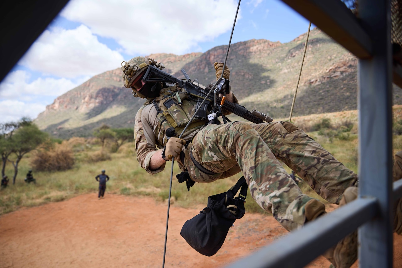 An airman rappels during military training.