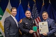 Suffolk County Executive Ed Romaine (right), and Suffolk Police Commissioner Robert Waring (left) present Officer Sean Kalletta of Suffolk County Police Department, also a Soldier with the 200th Military Police Command, with the Carnegie Medal, Feb. 22, 2024, in Hauppauge, New York. The Carnegie Medal recognizes individuals who risk serious injury while saving or attempting to save the lives of others. (U.S. Army Reserve photo by Sgt. Maria Casneiro) (Sgt. Maria Casneiro)