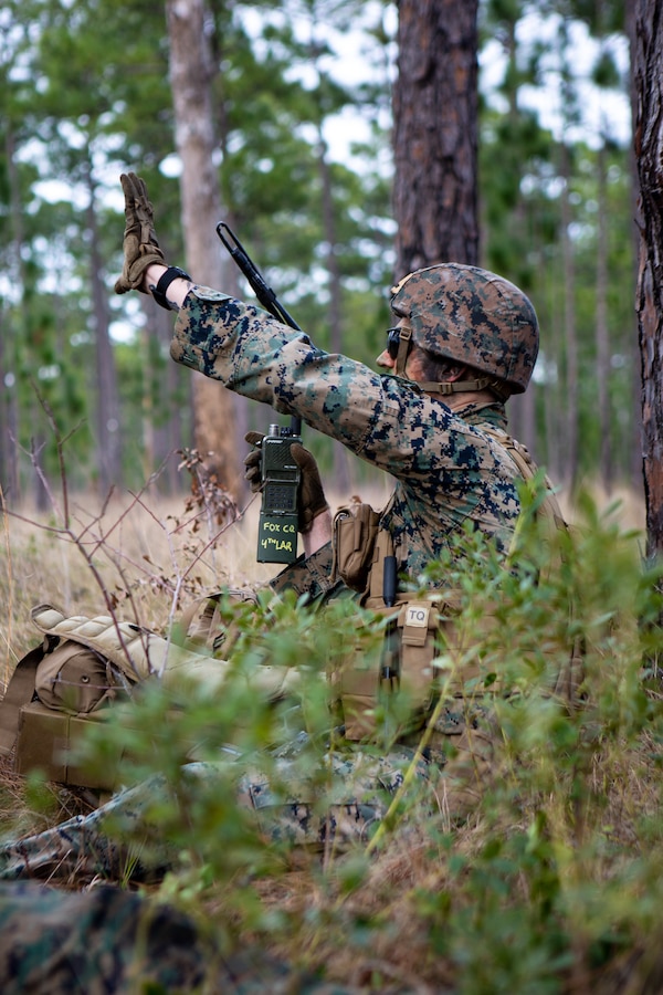 U.S. Marine Corps Sgt. Noah Swiney, a scout team leader with 4th Light Armored Reconnaissance Battalion, 4th Marine Division (MARDIV), Marine Forces Reserve, gives hand and arm signals to his squad during a patrol as part of the 4th MARDIV Rifle Squad Competition on Marine Corps Base (MCB) Camp Lejeune, North Carolina, March 8, 2024. The three-day event tested the Marines across a variety of infantry skills to determine the most combat effective rifle squad within the 4th MARDIV. MCB Camp Lejeune training facilities allow warfighters to be ready today and prepare for tomorrow’s fight. (U.S. Marine Corps Photo by Lance Cpl. Daniela Chicas Torres)