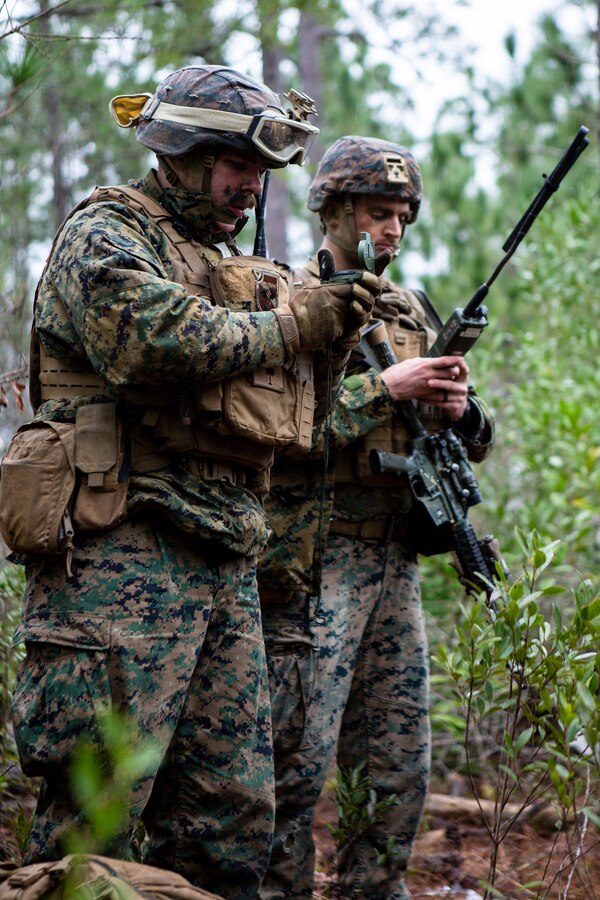 U.S. Marine Corps Cpl. Logan Chisholm, left, an automatic rifleman, and Sgt. Noah Swiney, a squad leader, both with 4th Light Armored Reconnaissance Battalion, 4th Marine Division (MARDIV), Marine Forces Reserve, practice land navigation during the 4th MARDIV Rifle Squad Competition on Marine Corps Base (MCB) Camp Lejeune, North Carolina, March 9, 2024. The three-day event tested the Marines across a variety of infantry skills to determine the most combat effective rifle squad within the 4th MARDIV. MCB Camp Lejeune training facilities allow warfighters to be ready today and prepare for tomorrow’s fight. (U.S. Marine Corps Photo by Lance Cpl. Daniela Chicas Torres)