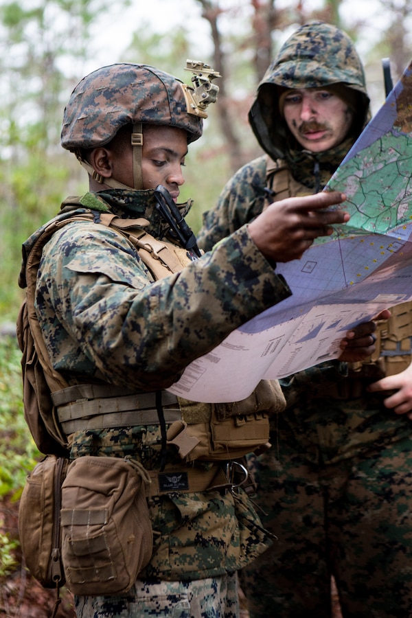 U.S. Marine Corps Cpl. Brandon Holliman, left, a team leader, and Cpl. Logan Chisholm, an automatic rifleman, both with 4th Light Armored Reconnaissance Battalion, 4th Marine Division (MARDIV), Marine Forces Reserve, review grid coordinates during the 4th MARDIV Rifle Squad Competition on Marine Corps Base (MCB) Camp Lejeune, North Carolina, March 9, 2024. The three-day event tested the Marines across a variety of infantry skills to determine the most combat effective rifle squad within the 4th MARDIV. MCB Camp Lejeune training facilities allow warfighters to be ready today and prepare for tomorrow’s fight. (U.S. Marine Corps Photo by Lance Cpl. Daniela Chicas Torres)