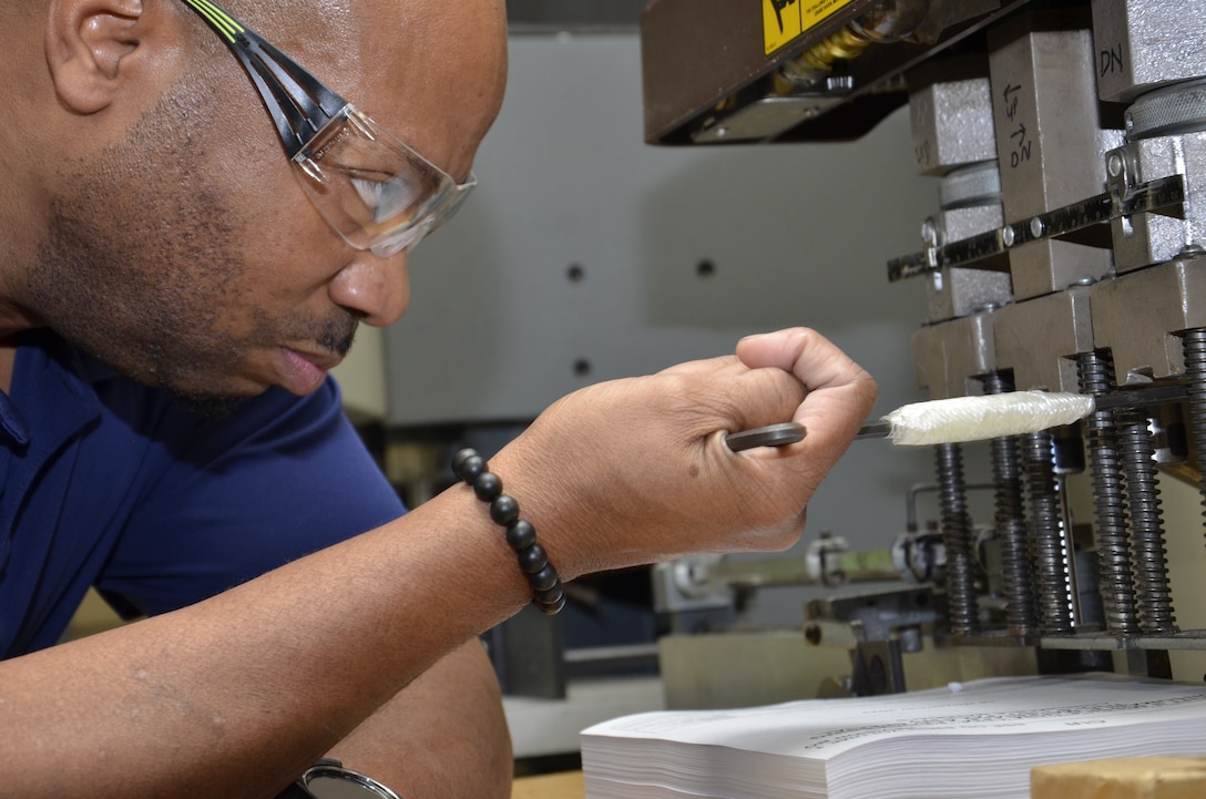 Man operates printing equipment