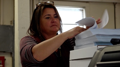 Woman binding a book
