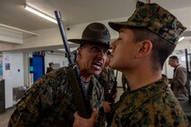 U.S. Marine Corps Staff Sgt. Mario Nunez, a drill instructor with Kilo Company, 3rd Recruit Training Battalion, inspects a recruit during a senior drill instructor inspection at Marine Corps Recruit Depot San Diego, California, March 7, 2024. The SDI Inspection is the first of several inspections recruits will undergo throughout the duration of their training at MCRD San Diego and aims to ensure the recruits are upholding the standards of the Marine Corps. (U.S. Marine Corps photo by Cpl. Joshua M. Dreher)