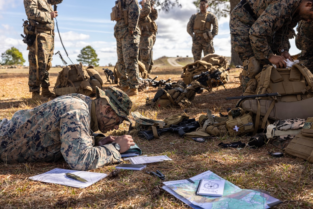 U.S. Marine Corps Cpl. Joshua Juni, a squad leader with Golf Company, 2nd Battalion, 23rd Marine Regiment, 4th Marine Division (MARDIV), Marine Forces Reserve, marks grid coordinates before conducting patrol-based operations during the 4th MARDIV Rifle Squad Competition on Marine Corps Base (MCB) Camp Lejeune, North Carolina, March 8, 2024. The three-day event tested the Marines across a variety of infantry skills to determine the most combat effective rifle squad within the 4th MARDIV. MCB Camp Lejeune training facilities allow warfighters to be ready today and prepare for tomorrow’s fight. (U.S. Marine Corps Photo by Cpl. Antonino Mazzamuto)