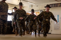 U.S. Marine Corps drill instructors with Kilo Company, 3rd Recruit Training Battalion, run into a squad bay marking the beginning of the senior drill instructor inspection at Marine Corps Recruit Depot San Diego, California, March 7, 2024. The SDI Inspection is the first of several inspections recruits will undergo throughout the duration of their training at MCRD San Diego and aims to ensure the recruits are upholding the uniform orders given to them. (U.S. Marine Corps photo by Cpl. Joshua M. Dreher)