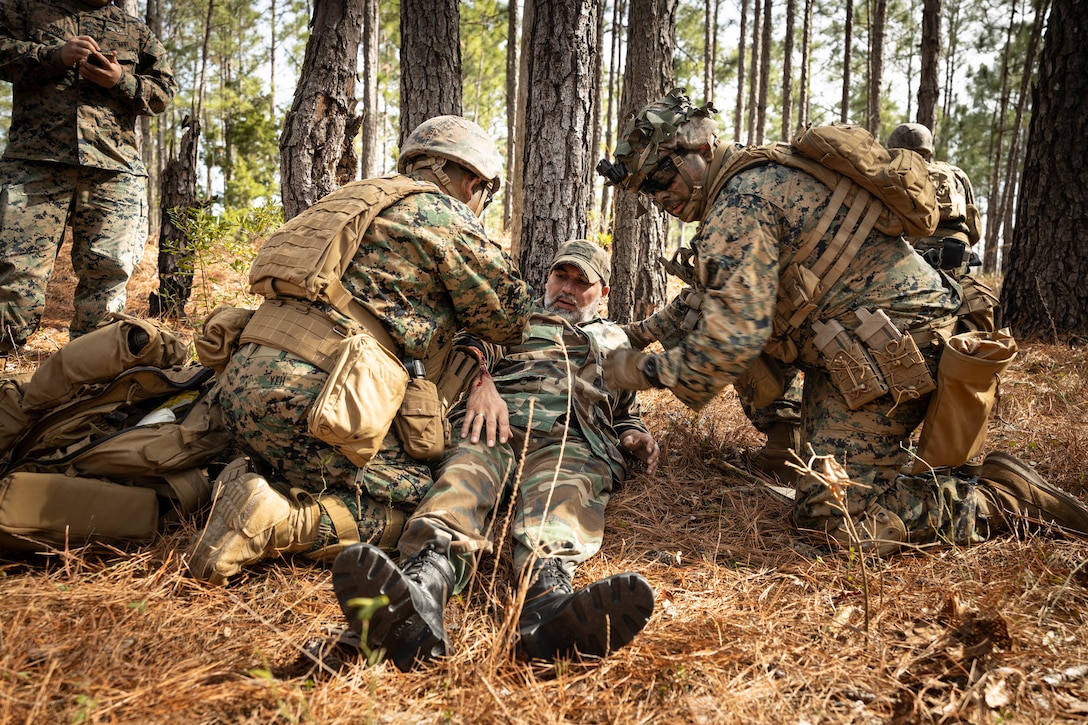 U.S. Marines with Golf Company, 2nd Battalion, 23rd Marine Regiment, 4th Marine Division (MARDIV), Marine Forces Reserve, conduct tactical combat casualty care on a role-player during the 4th MARDIV Rifle Squad Competition on Marine Corps Base (MCB) Camp Lejeune, North Carolina, March 8, 2024. The three-day event tested the Marines across a variety of infantry skills to determine the most combat effective rifle squad within the 4th MARDIV. MCB Camp Lejeune training facilities allow warfighters to be ready today and prepare for tomorrow’s fight. (U.S. Marine Corps Photo by Cpl. Antonino Mazzamuto)