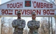 Captains Tamia (left) and Tamera (right) Grady pose under a 90th Sustainment Brigade monument on Camp Robinson, Ar. on February 23, 2024. The sisters were selected for company command and simultaneously commanded logistics units within the 90th Sust. Bde.