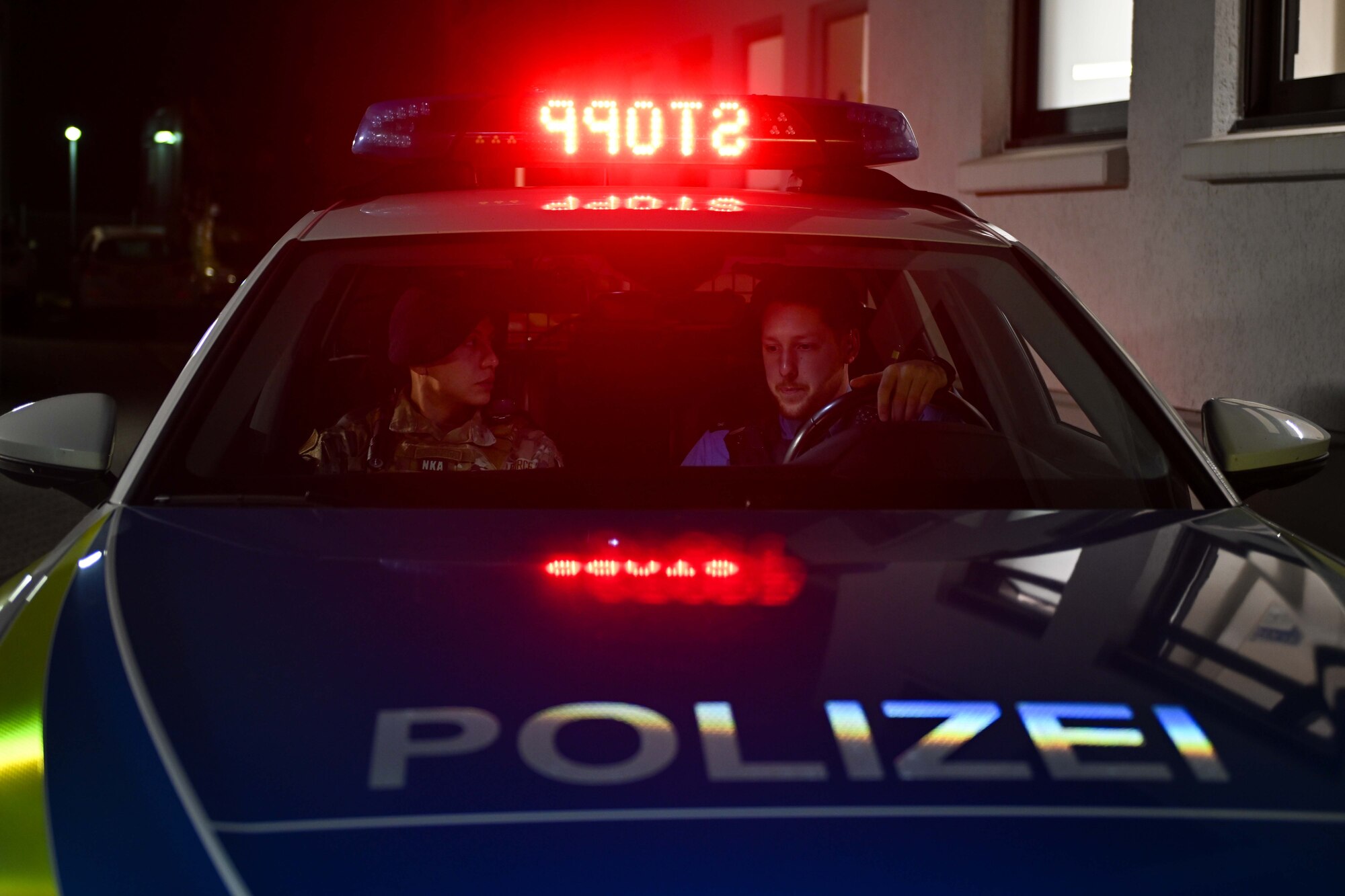 Joshua Smith, Polizeikommissar with the Bitburg Polizei, shows U.S. Air Force Senior Airman Samuel Landreth, 52nd Security Forces Squadron patrolman, functions of a Polizei cruiser during a joint patrol at the Bitburg Polizei Station, March 16, 2024.