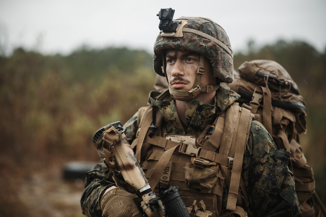 U.S. Marine Corps Lance Cpl. Caven Heffernan, an assistant gunner with 1st Battalion, 25th Marine Regiment, 4th Marine Division (MARDIV), Marine Forces Reserve, analyzes forward terrain during the 4th MARDIV Rifle Squad Competition on Marine Corps Base (MCB) Camp Lejeune, North Carolina, March 9, 2024. The three-day event tested the Marines across a variety of infantry skills to determine the most combat effective rifle squad within the 4th MARDIV. MCB Camp Lejeune training facilities allow warfighters to be ready today and prepare for tomorrow’s fight. (U.S. Marine Corps Photo by Cpl. Jorge Borjas)