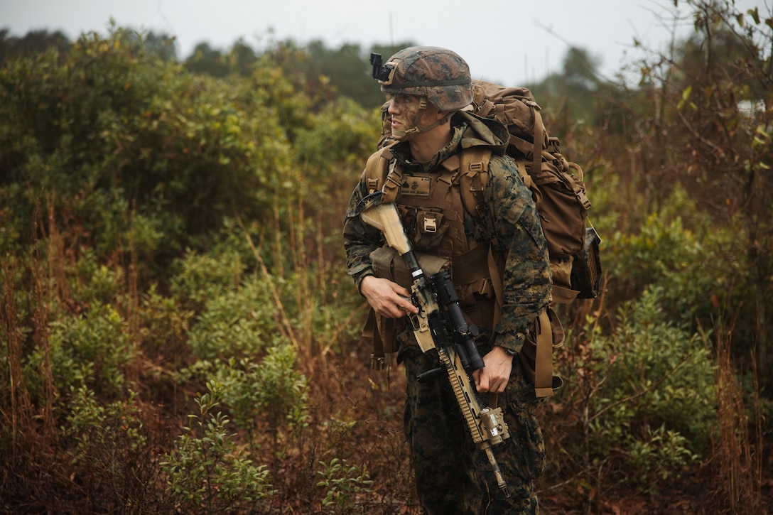 U.S. Marine Corps Cpl. Michael Tyer, a team leader with 1st Battalion, 25th Marine Regiment, 4th Marine Division (MARDIV), Marine Forces Reserve, advances forward while conducting a patrol during the 4th MARDIV Rifle Squad Competition on Marine Corps Base (MCB) Camp Lejeune, North Carolina, March 9, 2024. The three-day event tested the Marines across a variety of infantry skills to determine the most combat effective rifle squad within the 4th MARDIV. MCB Camp Lejeune training facilities allow warfighters to be ready today and prepare for tomorrow’s fight. (U.S. Marine Corps Photo by Cpl. Jorge Borjas)