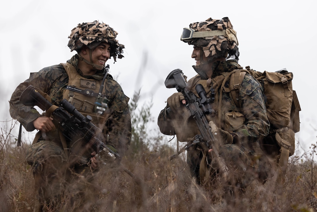 U.S. Marine Corps Cpl. Simon Tumbleson, left, squad leader, and Lance Cpl. Zachary Payne, a rifleman, both with Golf Company, 2nd Battalion, 23rd Marine Regiment, 4th Marine Division (MARDIV), Marine Forces Reserve, share a laugh while preparing to move positions in the 4th MARDIV Rifle Squad Competition on Marine Corps Base (MCB) Camp Lejeune, North Carolina, March 9, 2024. The three-day event tested the Marines across a variety of infantry skills to determine the most combat effective rifle squad within the 4th MARDIV. MCB Camp Lejeune training facilities allow warfighters to be ready today and prepare for tomorrow’s fight. (U.S. Marine Corps Photo by Cpl. Antonino Mazzamuto)
