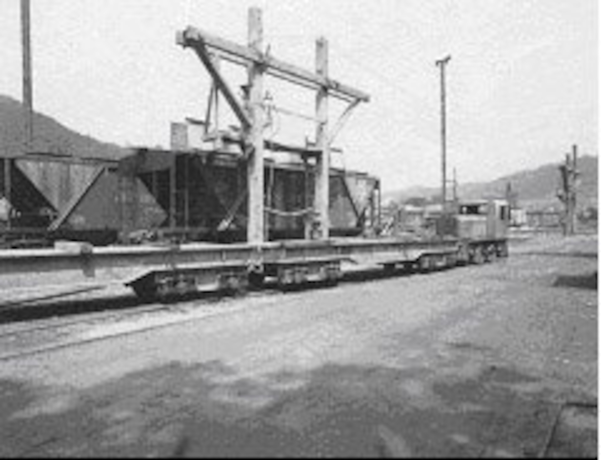 Historic photograph of a dinkey locomotive and car.