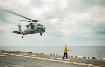 ABH3 Ashley Oscar launches an MH-60S Sea Hawk helicopter from HSC-25 aboard USS America (LHA 6).