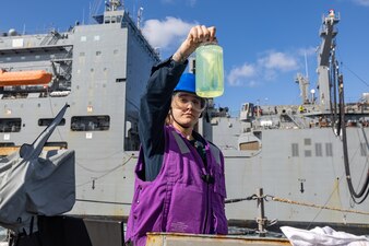GSM Natalee Howington checks a fuel sample aboard USS Higgins (DDG 76) during a replenishment with USNS Cesar Chavez (T-AKE 14).