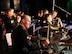 man wearing u.s. army uniform plays the drums.