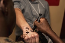 U.S. Marine Corps Recruit Christian Rodriguez with Lima Company, 3rd Recruit Training Battalion, receives measurements for clothing issue during receiving at Marine Corps Recruit Depot San Diego, California, March 11, 2024. During the receiving process drill instructors are responsible for ensuring recruits are checked for contraband, given haircuts, make a phone call home, and are issued the gear necessary for training. (U.S. Marine Corps photo by Sgt. Yvonna Guyette)