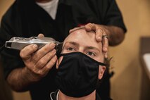 U.S. Marine Corps Recruit Colton Thomas with Lima Company, 3rd Recruit Training Battalion, receives a haircut during receiving at Marine Corps Recruit Depot San Diego, California, March 11, 2024. During the receiving process drill instructors are responsible for ensuring recruits are checked for contraband, given haircuts, make a phone call home, and are issued the gear necessary for training. (U.S. Marine Corps photo by Sgt. Yvonna Guyette)