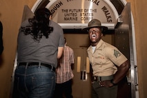 U.S. Marine Corps Sgt. Sharif Adan, a drill instructor with Receiving Company, Support Training Battalion, rushes recruits into the building during receiving at Marine Corps Recruit Depot San Diego, California, March 11, 2024. During the receiving process drill instructors are responsible for ensuring recruits are checked for contraband, given haircuts, make a phone call home, and are issued the gear necessary for training. (U.S. Marine Corps photo by Sgt. Yvonna Guyette)