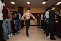 U.S. Marine Corps Sgt. Yulia Khandryka, a drill instructor with Receiving Company, Support Training Battalion, rushes recruits during the contraband brief as a part of receiving at Marine Corps Recruit Depot San Diego, California, March 11, 2024. During the receiving process drill instructors are responsible for ensuring recruits are checked for contraband, given haircuts, make a phone call home, and are issued the gear necessary for training. (U.S. Marine Corps photo by Sgt. Yvonna Guyette)