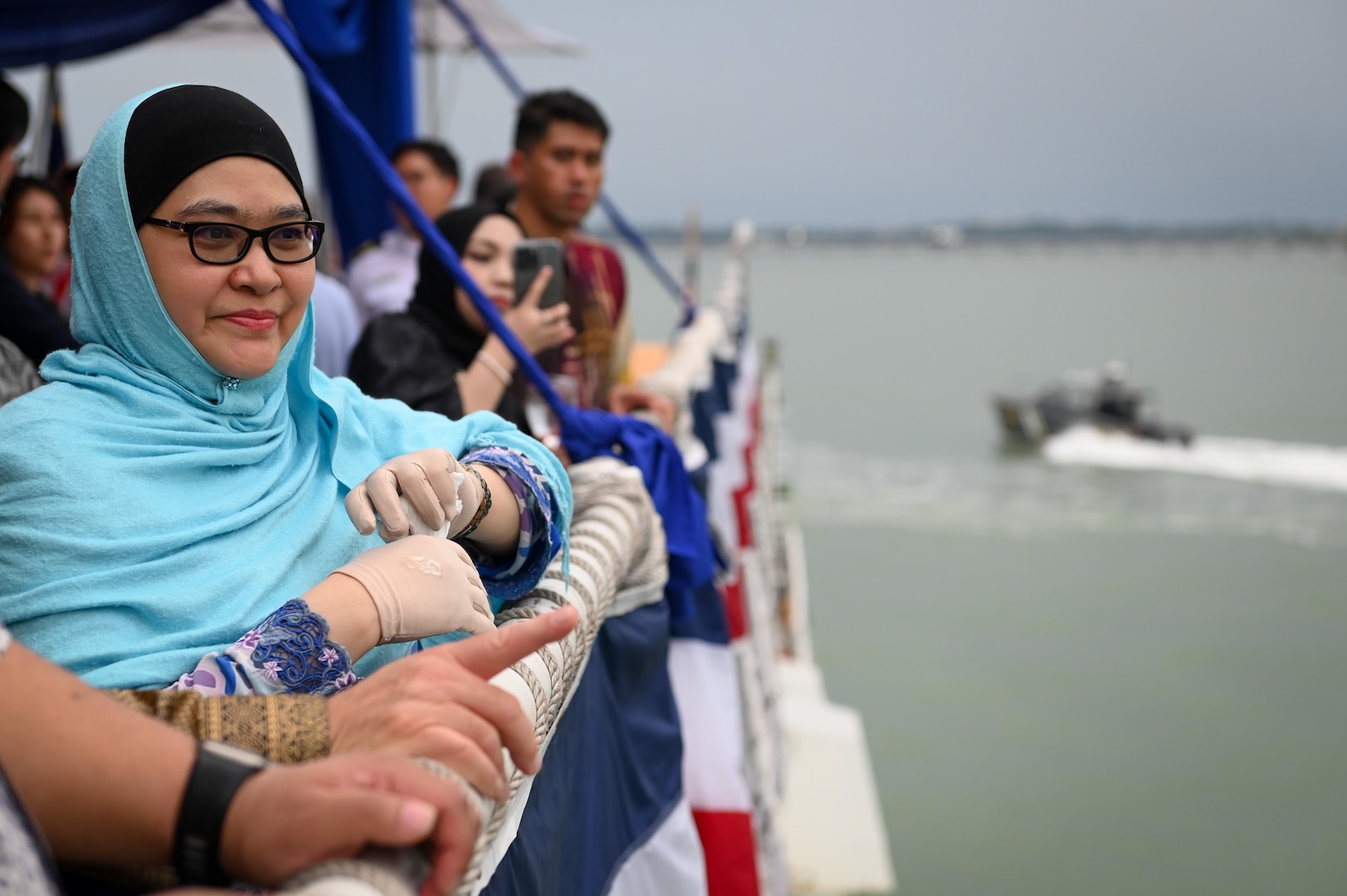 Dato’ Anis Rizana Binti Mohd Zainudin, the Director General of Royal Malaysian Customs, watches several customs boats transit near U.S. Coast Guard Cutter Bertholf (WMSL 750) while the cutter was moored in Port Klang, Malaysia, March 2, 2024. This was the first time a U.S. Coast Guard vessel has moored in Port Klang. (U.S. Coast Guard photo by Petty Officer Steve Strohmaier)