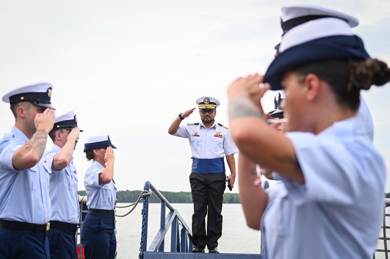 Capt. Abdul Muhaimin Bin Muhammad Salleh, Malaysian Maritime Enforcement Agency, salutes as he arrives aboard U.S. Coast Guard Cutter Bertholf (WMSL 750) during a reception held aboard the cutter while it was moored in Port Klang, Malaysia, March 2, 2024. The event, hosted by the crew of the Bertholf, brought together dignitaries from multiple Malaysian government agencies. (U.S. Coast Guard photo by Petty Officer Steve Strohmaier)