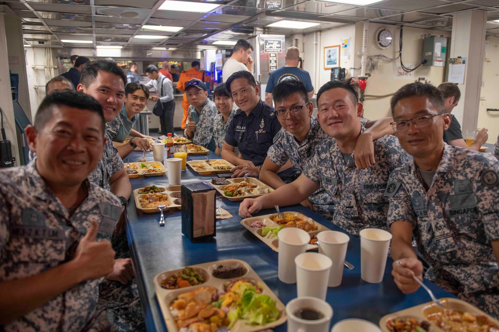 Members of the Republic of Singapore Navy pose for a photo while eating lunch onboard U.S. Coast Guard Cutter Bertholf (WMSL 750), March 3. Bertholf was in Malaysia for a multiple day engagement which directly supports U.S. foreign policy and national security objectives in the Indo-Pacific Strategy and the National Security Strategy. (U.S. Navy photo taken by Mass Communication Specialist 3rd Class Charlotte Duran)