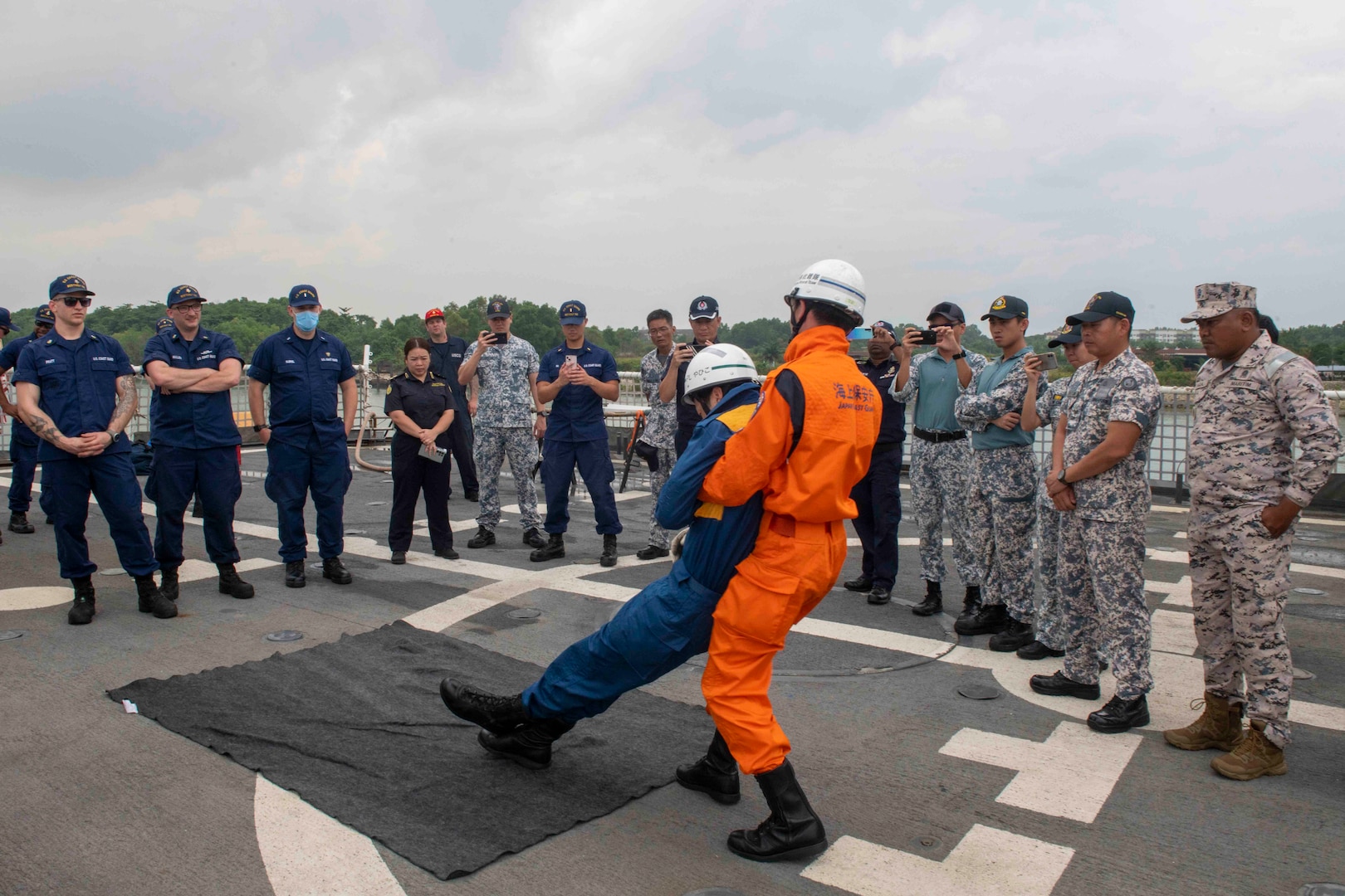 Members of the Japanese Coast Guard give tactical training on how to move a body during a subject matter exchange to members of the Republic of Singapore Navy, members of the Singapore Police Coast Guard, members of the Malaysia Maritime Enforcement Agency, and Sailors onboard U.S. Coast Guard Cutter Bertholf (WMSL 750), March 3. Bertholf was in Malaysia for a multiple day engagement to engage in professional subject matter exchanges with regional partners and allies and will patrol and operate as directed during their Western Pacific deployment. (U.S. Navy photo taken by Mass Communication Specialist 3rd Class Charlotte Duran)