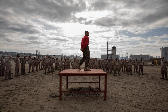 U.S. Marine Corps Staff Sgt. Deandre Lee, a drill instructor with Charlie Company, 1st Recruit Training Battalion, leads warm-up exercises for recruits before they execute the confidence course at Marine Corps Recruit Depot San Diego, California, March 11, 2024. The confidence course is designed to challenge recruits physically and mentally through the execution of obstacles that require strength, balance, and determination. (U.S. Marine Corps photo by Cpl. Sarah M. Grawcock)