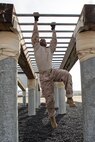 U.S. Marine Corps Recruit Charles Lee III, with Charlie Company, 1st Recruit Training Battalion, navigates the arm stretch obstacle during a confidence course training event at Marine Corps Recruit Depot San Diego, California, March 11, 2024. The confidence course is designed to challenge recruits physically and mentally through the execution of obstacles that require strength, balance, and determination. (U.S. Marine Corps photo by Cpl. Sarah M. Grawcock)