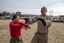 U.S. Marine Corps Sgt. Jessica Monaghan, a drill instructor with Charlie Company, 1st Recruit Training Battalion, provides instructions to Recruit Zeke Davila during a confidence course training event at Marine Corps Recruit Depot San Diego, California, March 11, 2024. The confidence course is designed to challenge recruits physically and mentally through the execution of obstacles that require strength, balance, and determination. (U.S. Marine Corps photo by Cpl. Sarah M. Grawcock)