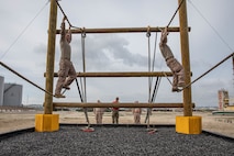 U.S. Marine Corps recruits with Charlie Company, 1st Recruit Training Battalion, traverse across an obstacle during a Marine Corps Confidence Course training event at Marine Corps Recruit Depot San Diego, California, March 11, 2024. The confidence course is designed to challenge recruits physically and mentally through the execution of obstacles that require strength, balance, and determination. (U.S. Marine Corps photo by Cpl. Sarah M. Grawcock)