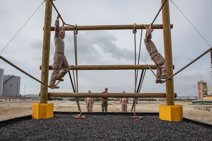 U.S. Marine Corps recruits with Charlie Company, 1st Recruit Training Battalion, traverse across an obstacle during a Marine Corps Confidence Course training event at Marine Corps Recruit Depot San Diego, California, March 11, 2024. The confidence course is designed to challenge recruits physically and mentally through the execution of obstacles that require strength, balance, and determination. (U.S. Marine Corps photo by Cpl. Sarah M. Grawcock)