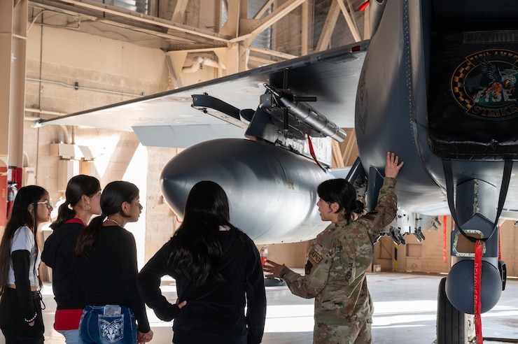 U.S. Air Force Senior Airman Rosamaria Munoz, 757th Aircraft Maintenance Squadron Strike Aircraft Maintenance Unit, speaks with students about the 7-15E Strike Eagle on Nellis Air Force Base, Nevada, Feb. 26, 2024.