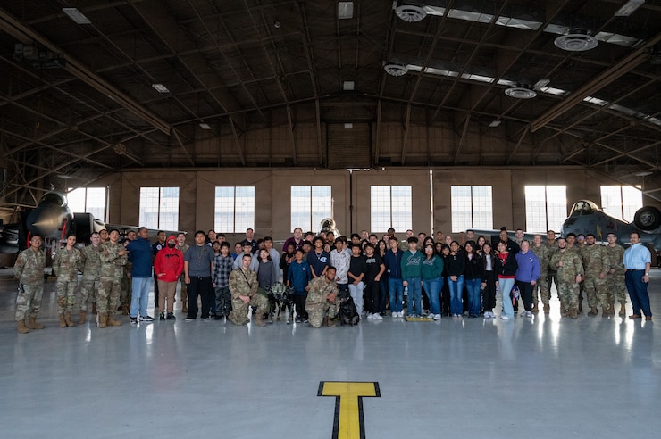 U.S. Air Force Airmen pose for a photo with students on Nellis Air Force Base, Nevada, Feb. 26, 2024.