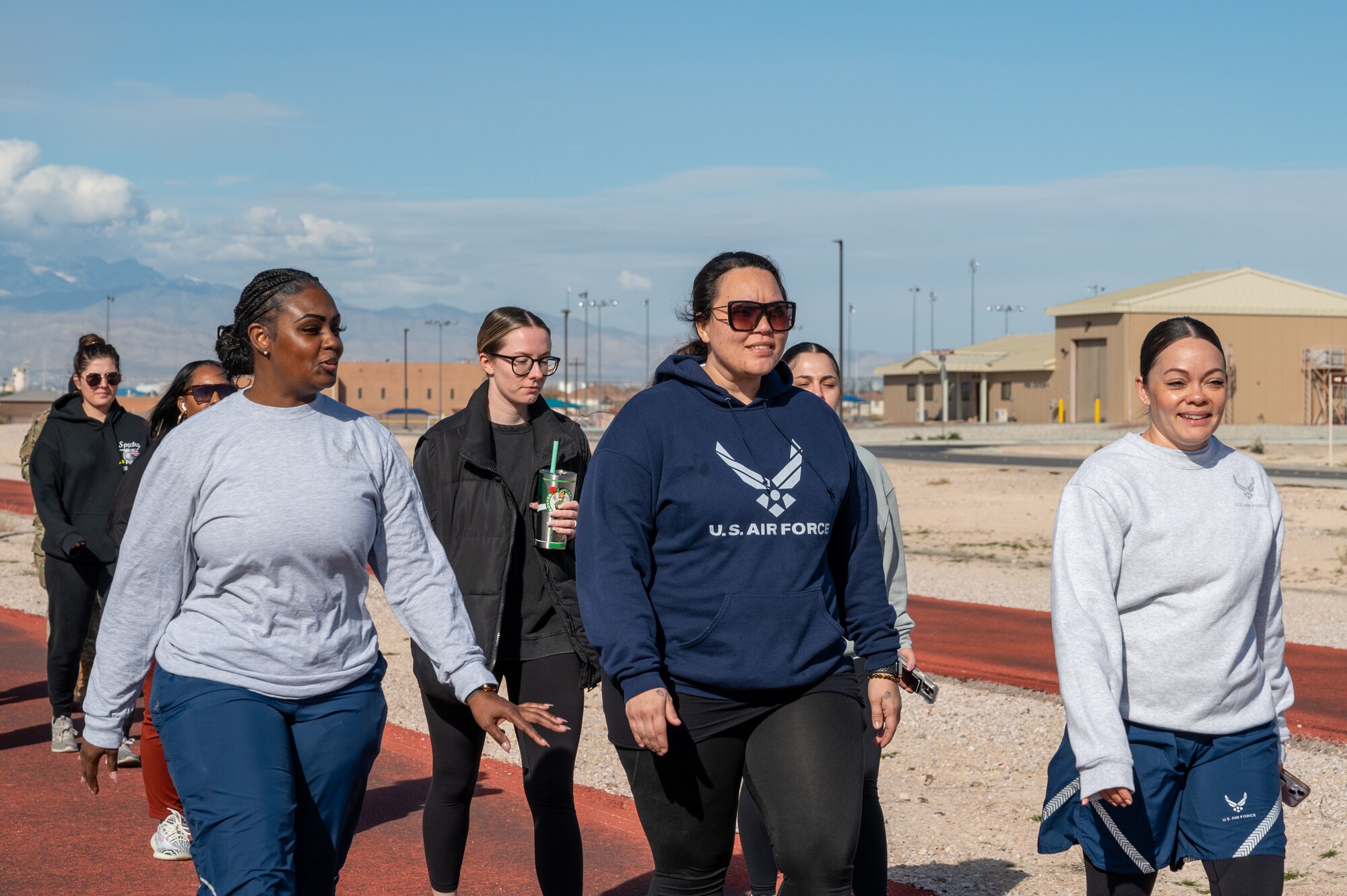 U.S. Air Force Airmen and community members participate in the Women Everywhere Walk at Nellis Air Force Base, Nevada, March 7, 2024.
