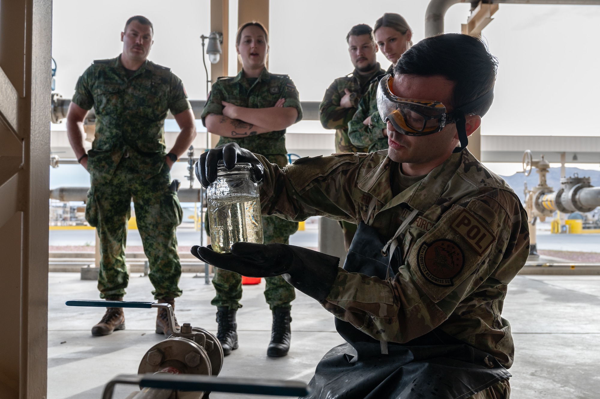 U.S. Air Force Staff Sgt. Glen Foster, a Fuels Facilities Supervisor assigned to the 99th Logistics Readiness Squadron, drains a filter sump at Nellis Air Force Base, Nevada, March 11, 2024.