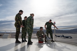 U.S. Air Force Staff Sgt. Glen Foster, a Fuels Facilities Supervisor assigned to the 99th Logistics Readiness Squadron (center), shows Royal Netherland Air Force airmen various methods on how to monitor fuel tank levels during Red Flag-Nellis 24-2 at Nellis Air Force Base, Nevada, March 11, 2024.