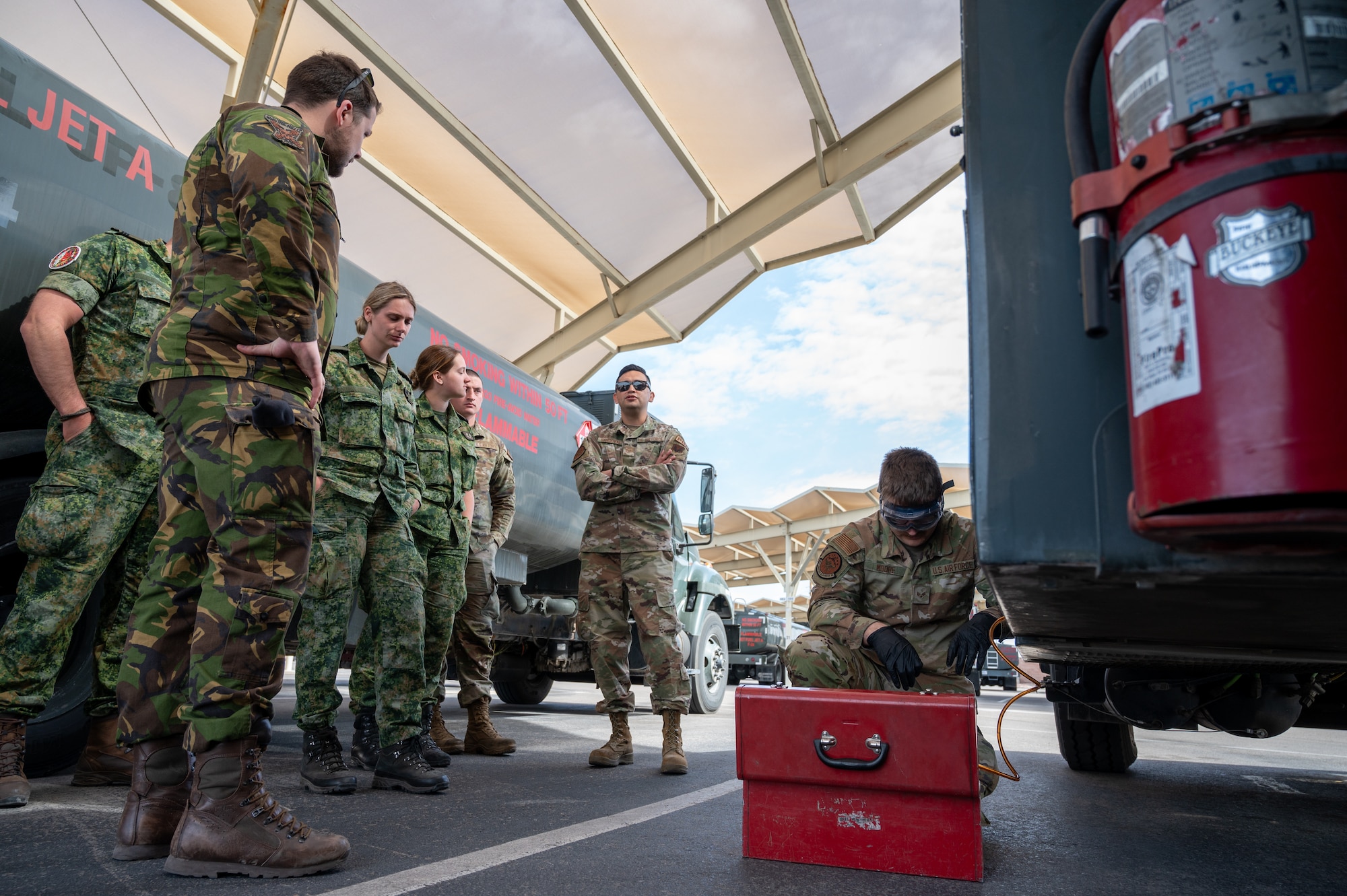 U.S. Air Force Airmen assigned to the 99th Logistics Readiness Squadron Fuels Management Flight show Royal Netherlands Air Force airmen how fuel samples are taken from refueling vehicles at Nellis Air Force Base, Nevada, March 11, 2024.