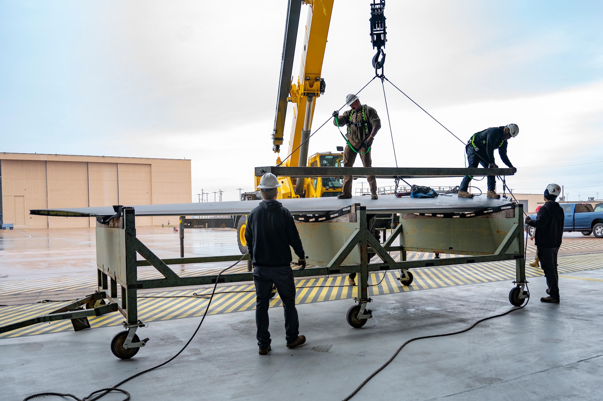 Airmen from the 76th Aircraft Maintenance Group’s Expeditionary Depot Maintenance Flight at Tinker Air Force Base unload a piece of a B-1B Lancer horizontal stabilizer at Dyess Air Force Base, Texas, Dec. 14, 2023. After demilitarizing the aircraft, salvageable pieces were sent to various training units around Dyess. (U.S. Air Force photo by Airman 1st Class Emma Anderson)