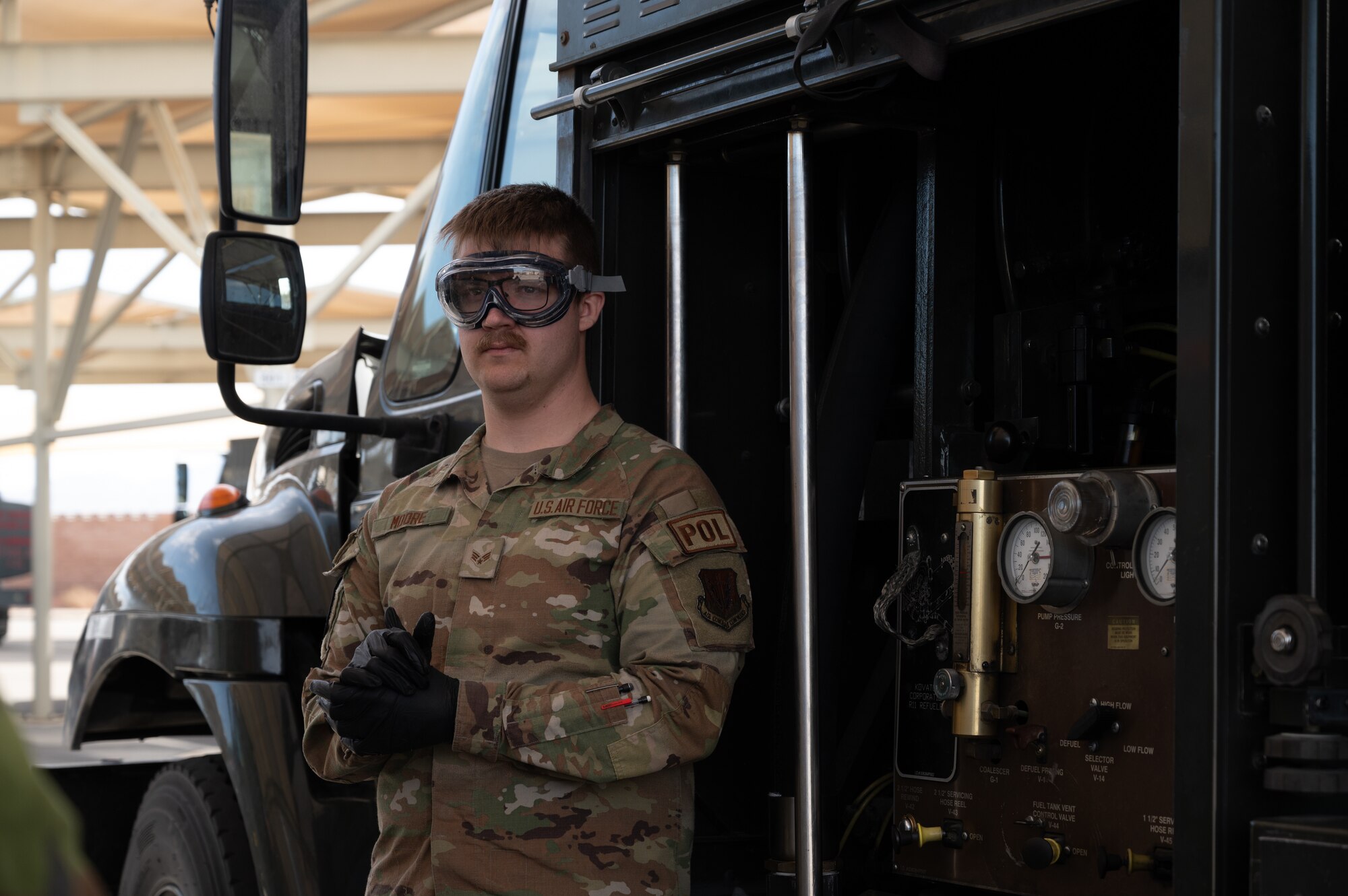 U.S. Air Force Senior Airman Jayce Moore, a Fuels Laboratory Technician assigned to the 99th Logistics Readiness Squadron, demonstrates how fuel samples are taken from refueling vehicles at Nellis Air Force Base, Nevada, March 11, 2024.
