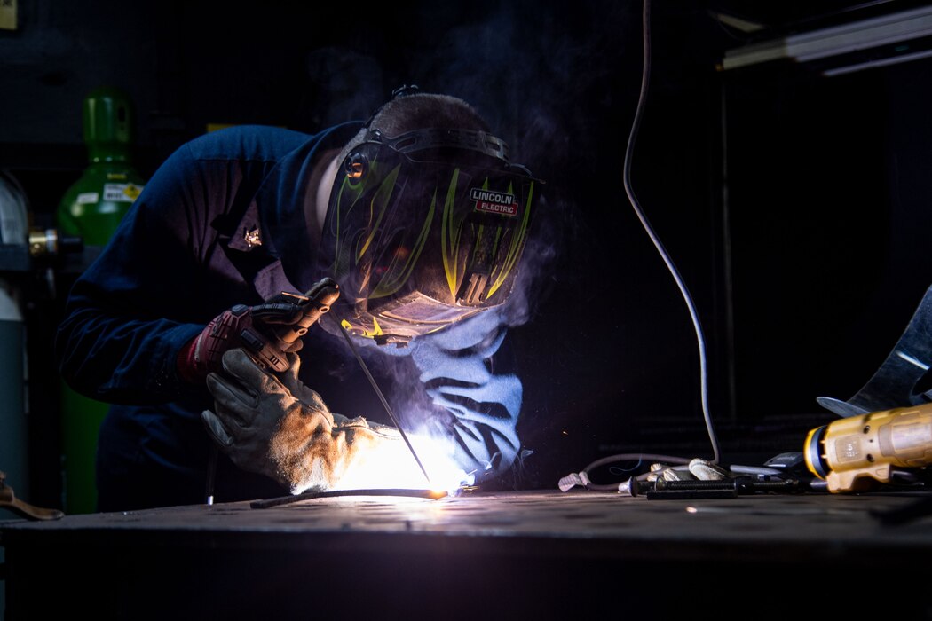 U.S. Navy Hull Maintenance Technician 3rd Class Aaron Gibbs practices his welding in the repair shop aboard the Nimitz-class aircraft carrier USS Theodore Roosevelt (CVN 71)